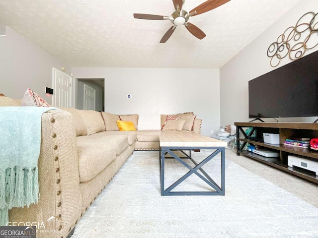 5553 Strathmoor Manor Cir, Lithonia, GA 30058 - living area with ceiling fan, a textured ceiling, and carpet flooring