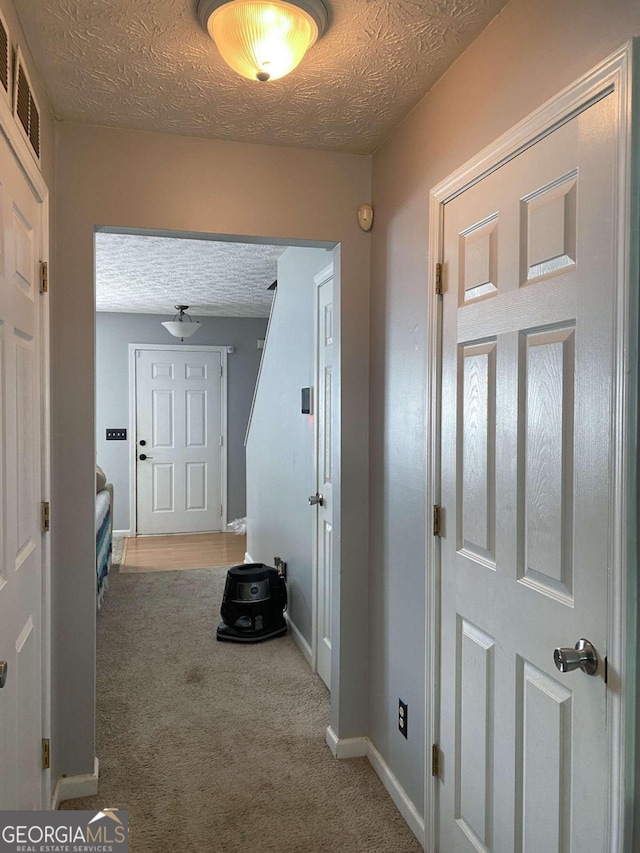 5553 Strathmoor Manor Cir, Lithonia, GA 30058 - hall with a textured ceiling and carpet