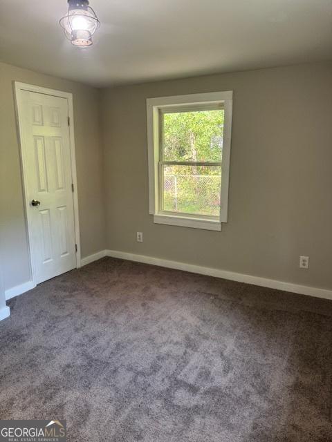 210 Bishop St, Marshallville, GA 31057 - unfurnished room featuring carpet floors and baseboards