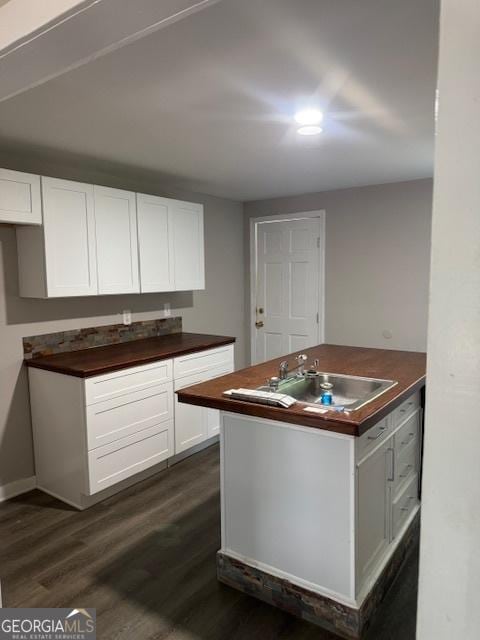 210 Bishop St, Marshallville, GA 31057 - kitchen with dark wood finished floors and white cabinetry