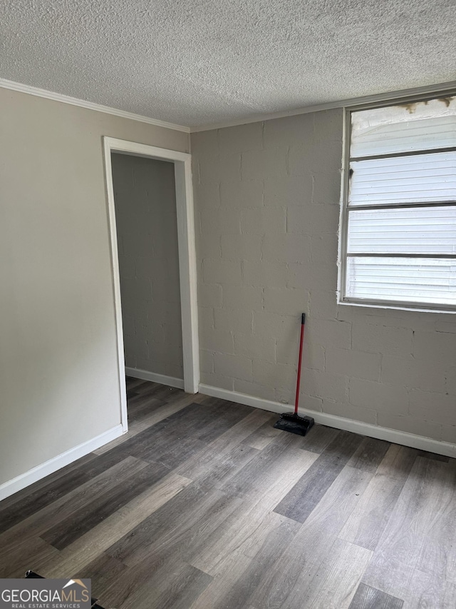 1040 Chestney St, Macon, GA 31217 - empty room featuring dark wood finished floors, a textured ceiling, and ornamental molding