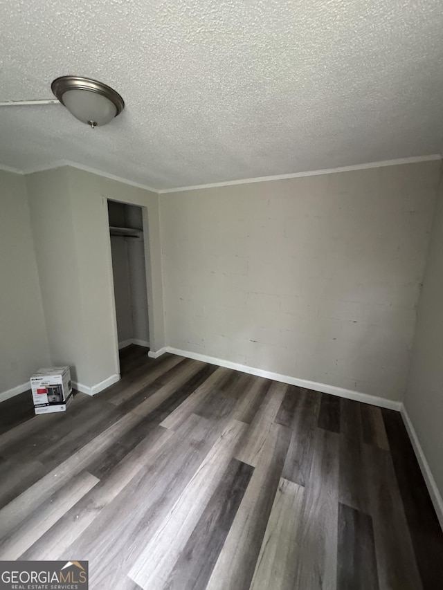 1040 Chestney St, Macon, GA 31217 - unfurnished bedroom with a textured ceiling, wood finished floors, a closet, and crown molding