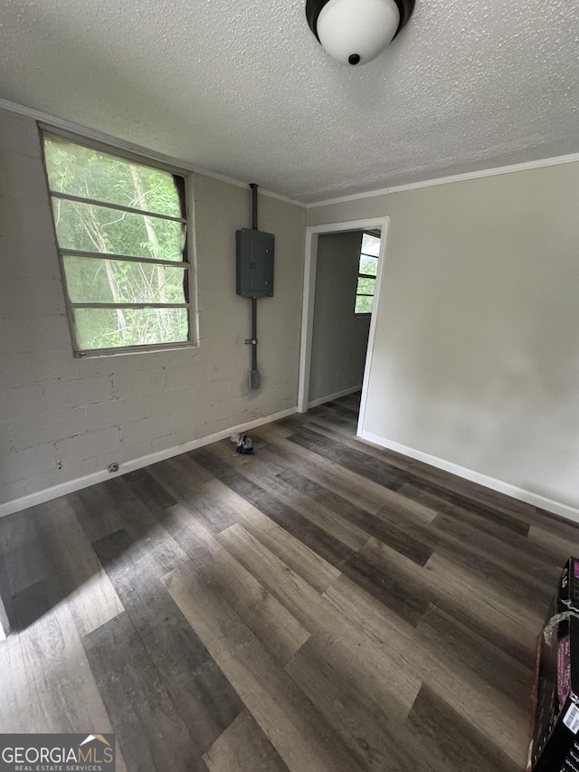 1040 Chestney St, Macon, GA 31217 - empty room featuring a textured ceiling, electric panel, wood finished floors, and crown molding