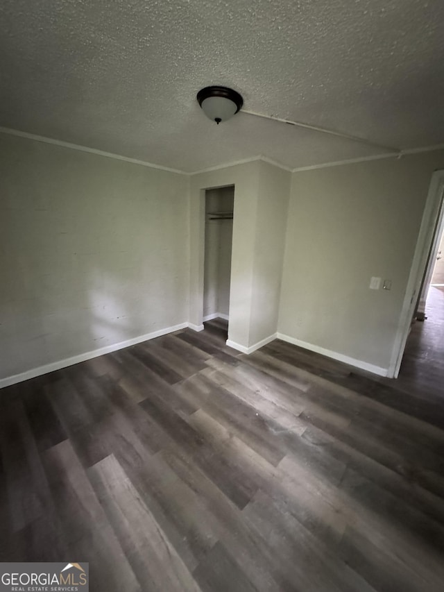 1040 Chestney St, Macon, GA 31217 - unfurnished bedroom with a textured ceiling, dark wood finished floors, crown molding, and a closet