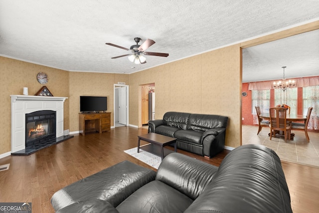 329 Summer Glen Rd, Dahlonega, GA 30533 - living room featuring a chandelier, a textured ceiling, ceiling fan, ornamental molding, and wood finished floors