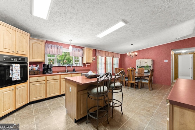 329 Summer Glen Rd, Dahlonega, GA 30533 - kitchen featuring black oven, light brown cabinets, a chandelier, and a textured ceiling
