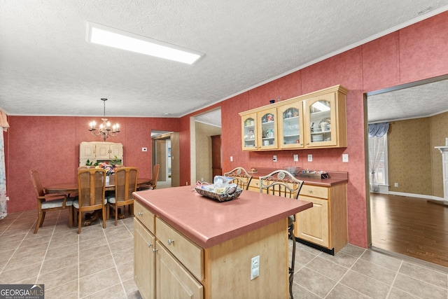 329 Summer Glen Rd, Dahlonega, GA 30533 - kitchen with a textured ceiling, a center island, a chandelier, light tile patterned flooring, and glass insert cabinets
