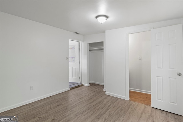 5861 Community Rd SE, Mableton, GA 30126 - unfurnished bedroom featuring light wood-type flooring and a closet