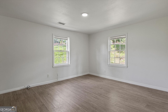 5861 Community Rd SE, Mableton, GA 30126 - unfurnished room featuring wood finished floors and healthy amount of natural light