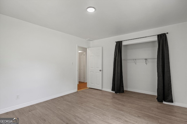 5861 Community Rd SE, Mableton, GA 30126 - unfurnished bedroom with wood finished floors and a closet