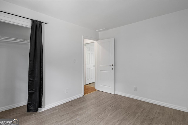 5861 Community Rd SE, Mableton, GA 30126 - unfurnished bedroom featuring wood finished floors and a closet