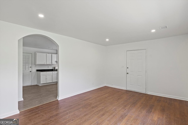 5861 Community Rd SE, Mableton, GA 30126 - empty room featuring wood finished floors, arched walkways, and recessed lighting