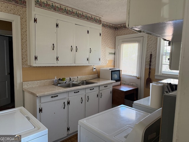 105 E Juniper Way SE, Rome, GA 30161 - kitchen featuring wallpapered walls, a textured ceiling, white cabinets, light countertops, and backsplash