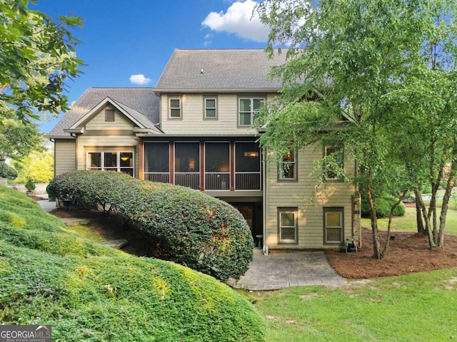 2118 Chatham, Dalton, GA 30720 - back of house featuring a patio, a sunroom, roof with shingles, and a lawn