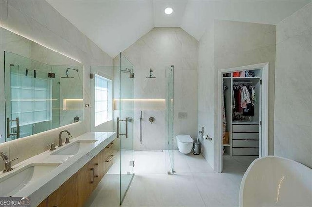 503 Rising Dr, Woodstock, GA 30189 - full bathroom with lofted ceiling, a shower stall, a spacious closet, a freestanding tub, and double vanity