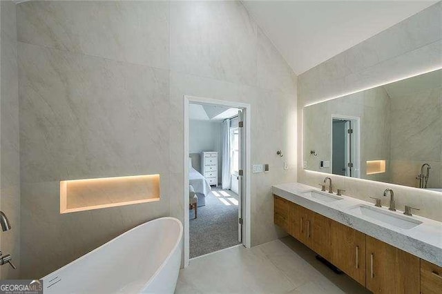 503 Rising Dr, Woodstock, GA 30189 - ensuite bathroom with lofted ceiling, a freestanding bath, and double vanity