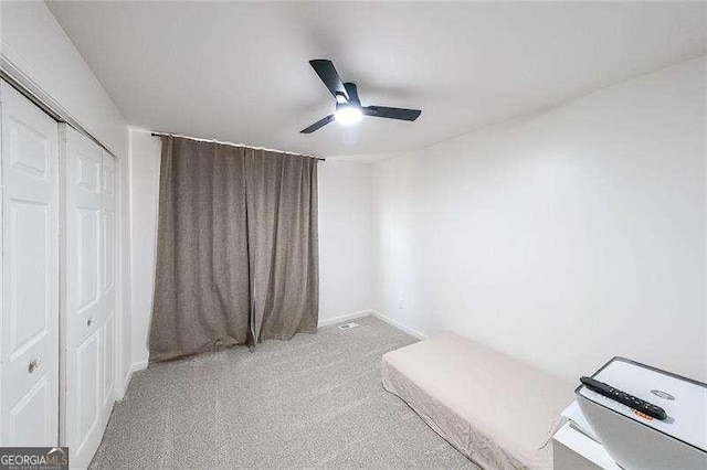 503 Rising Dr, Woodstock, GA 30189 - unfurnished bedroom with carpet floors, a closet, and a ceiling fan