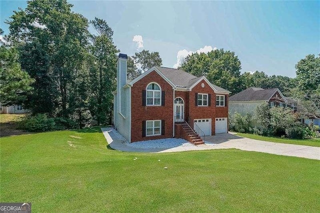 503 Rising Dr, Woodstock, GA 30189 - bi-level home featuring a chimney, concrete driveway, a garage, a front lawn, and brick siding