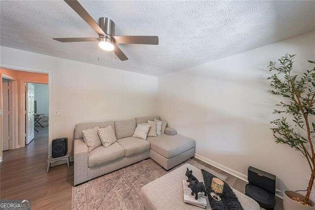 503 Rising Dr, Woodstock, GA 30189 - living room featuring wood finished floors, a textured ceiling, and a ceiling fan