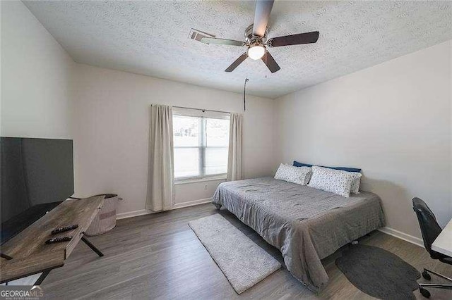 503 Rising Dr, Woodstock, GA 30189 - bedroom with wood finished floors, a textured ceiling, and ceiling fan