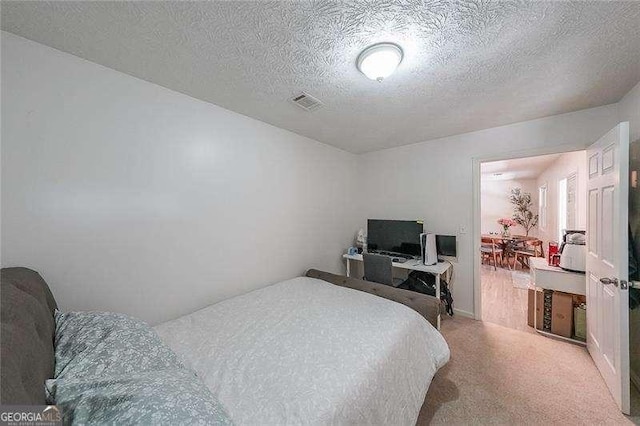 503 Rising Dr, Woodstock, GA 30189 - bedroom featuring a textured ceiling and light colored carpet