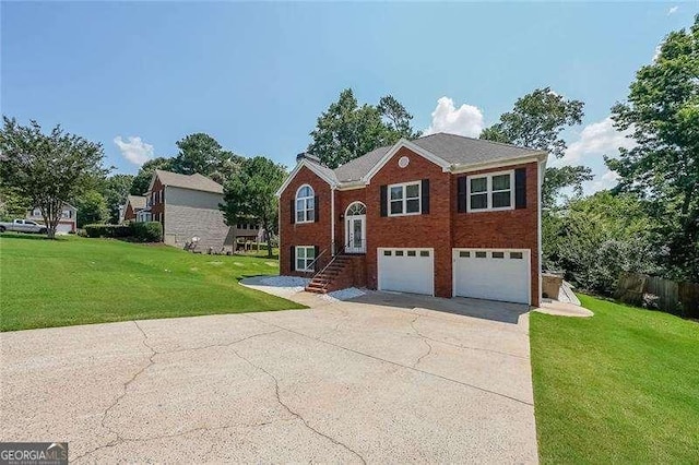 503 Rising Dr, Woodstock, GA 30189 - split foyer home featuring a garage, concrete driveway, a front lawn, and brick siding
