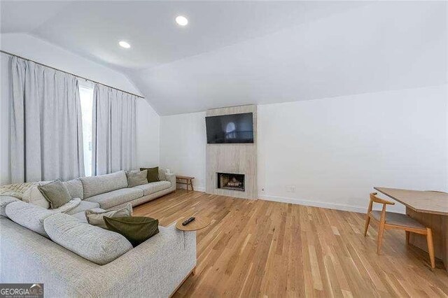 503 Rising Dr, Woodstock, GA 30189 - living area with vaulted ceiling, light wood-style floors, a fireplace, and recessed lighting