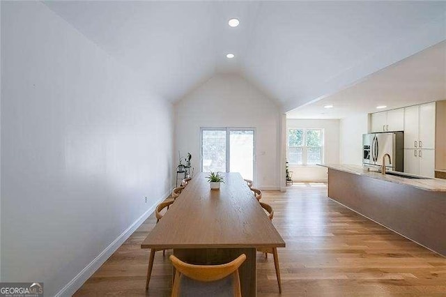 503 Rising Dr, Woodstock, GA 30189 - dining room featuring lofted ceiling, light wood-style floors, and recessed lighting