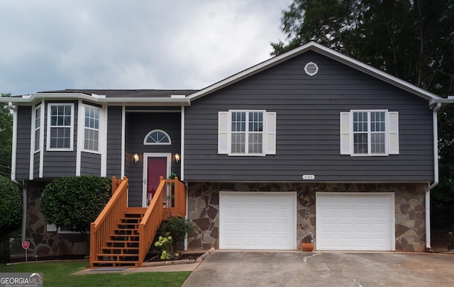 2333 Wilkins Cv, Decatur, GA 30035 - raised ranch featuring stone siding, a garage, and driveway