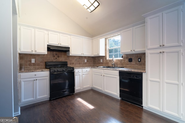 2333 Wilkins Cv, Decatur, GA 30035 - kitchen with black appliances, vaulted ceiling, under cabinet range hood, tasteful backsplash, and white cabinetry