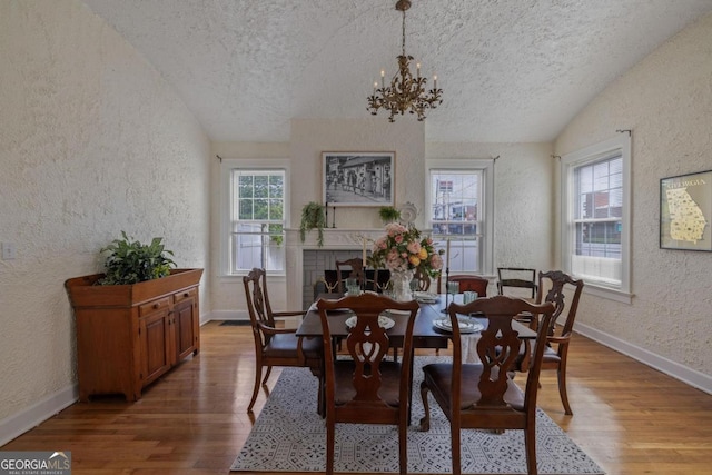 204 S Jefferson Ave, Eatonton, GA 31024 - dining space featuring a textured wall, a textured ceiling, vaulted ceiling, healthy amount of natural light, and light wood-style flooring