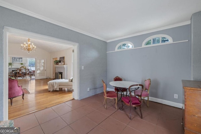 204 S Jefferson Ave, Eatonton, GA 31024 - tiled dining room with a chandelier, a brick fireplace, and crown molding