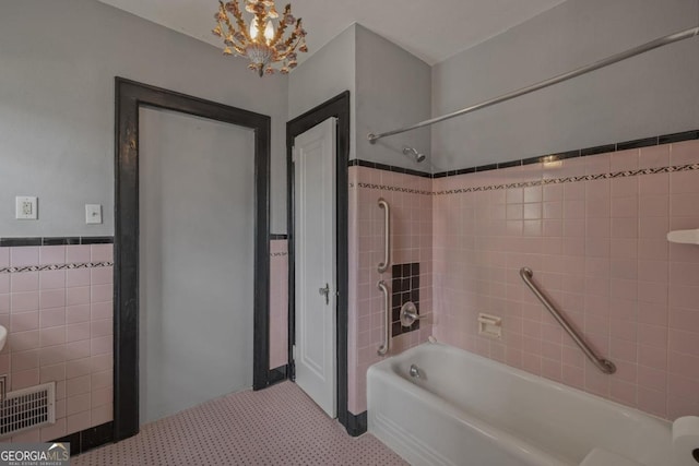 204 S Jefferson Ave, Eatonton, GA 31024 - full bath with  shower combination, tile walls, and a chandelier