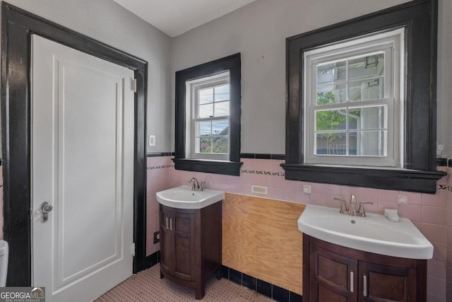 204 S Jefferson Ave, Eatonton, GA 31024 - bathroom with vanity, tile walls, and a wainscoted wall