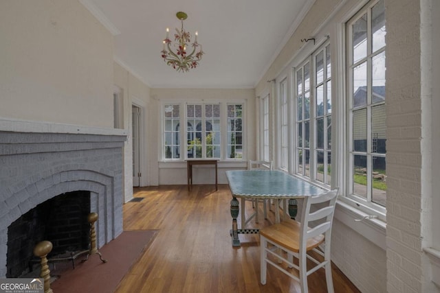 204 S Jefferson Ave, Eatonton, GA 31024 - sunroom / solarium featuring ornamental molding, healthy amount of natural light, wood finished floors, and a chandelier