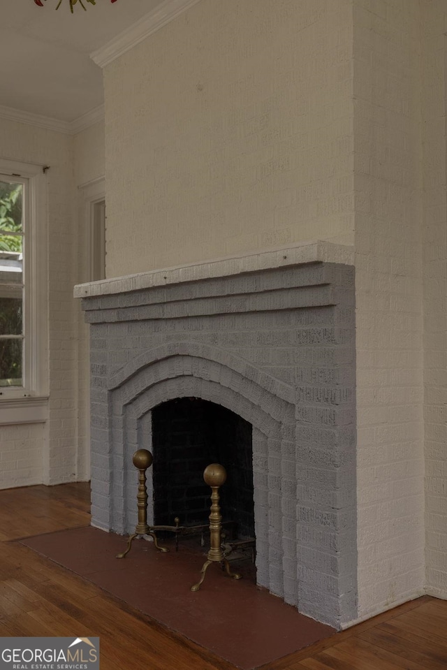204 S Jefferson Ave, Eatonton, GA 31024 - detailed view of wood finished floors, ornamental molding, and a fireplace