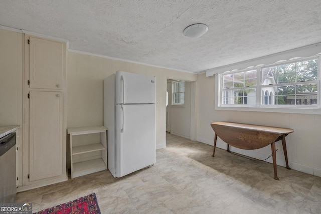 204 S Jefferson Ave, Eatonton, GA 31024 - kitchen featuring freestanding refrigerator, dishwasher, a textured ceiling, light flooring, and ornamental molding