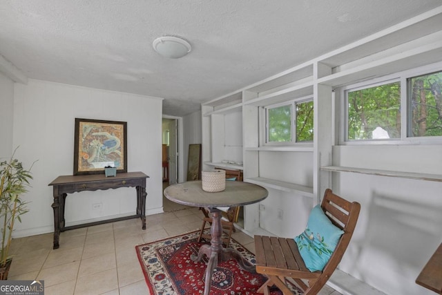204 S Jefferson Ave, Eatonton, GA 31024 - dining area with tile patterned flooring and a textured ceiling