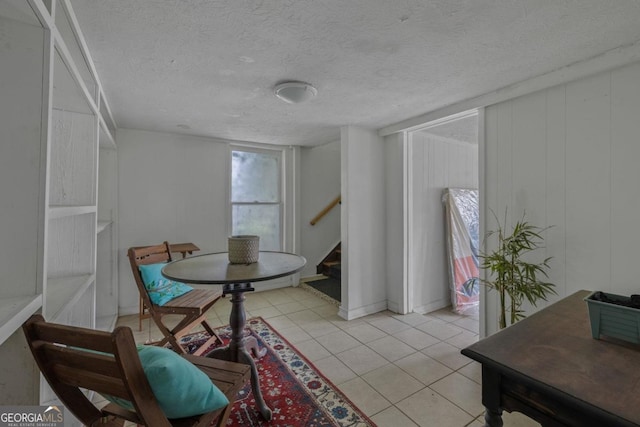 204 S Jefferson Ave, Eatonton, GA 31024 - dining space featuring stairway, light tile patterned floors, and a textured ceiling