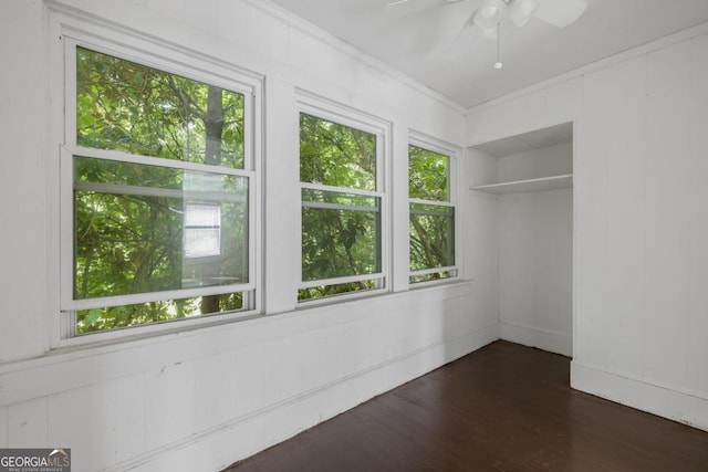 204 S Jefferson Ave, Eatonton, GA 31024 - empty room featuring a ceiling fan, dark wood-style flooring, and crown molding