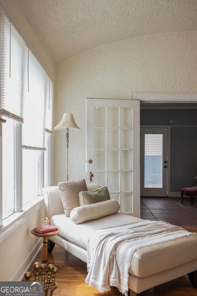 204 S Jefferson Ave, Eatonton, GA 31024 - bedroom with a textured wall, a textured ceiling, tile patterned floors, and vaulted ceiling
