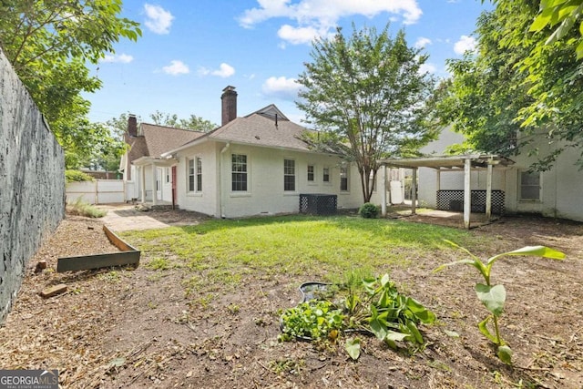 204 S Jefferson Ave, Eatonton, GA 31024 - back of property featuring a chimney, a fenced backyard, a pergola, and brick siding