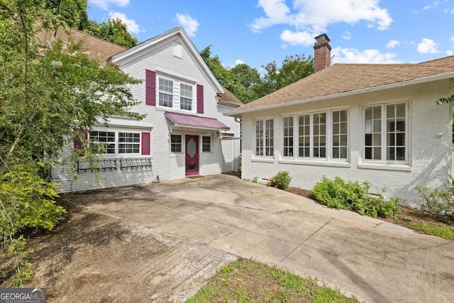 204 S Jefferson Ave, Eatonton, GA 31024 - view of front facade featuring a chimney and brick siding