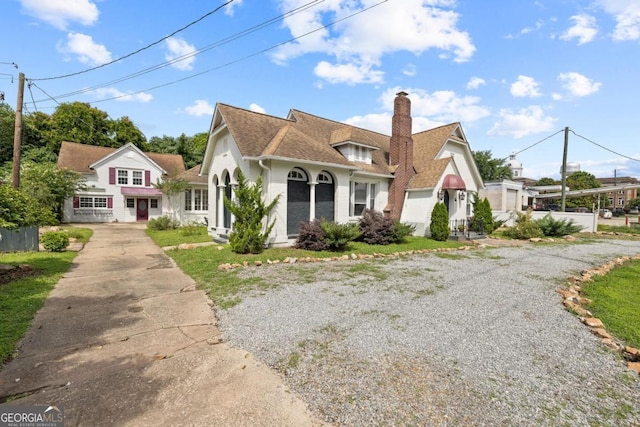 204 S Jefferson Ave, Eatonton, GA 31024 - view of front of home with concrete driveway, a chimney, and a shingled roof
