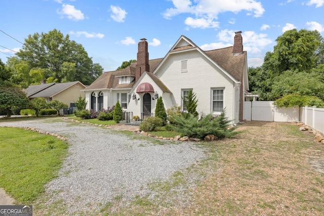 204 S Jefferson Ave, Eatonton, GA 31024 - tudor home with a chimney and brick siding