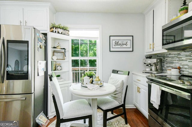 3024 Saddle Creek Dr, Gainesville, GA 30507 - kitchen featuring appliances with stainless steel finishes, decorative backsplash, white cabinetry, dark wood-style floors, and light countertops