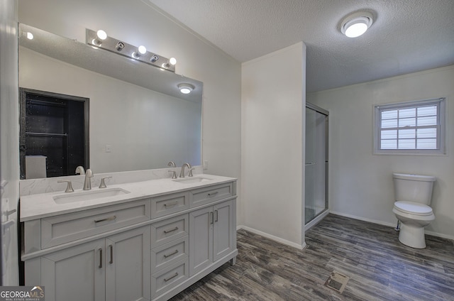 1525 Bailey Rd, Aragon, GA 30104 - bathroom featuring double vanity, a shower stall, wood finished floors, and a textured ceiling