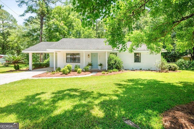 711 Chapman St, Blackshear, GA 31516 - ranch-style home with driveway, a carport, a front yard, and a shingled roof