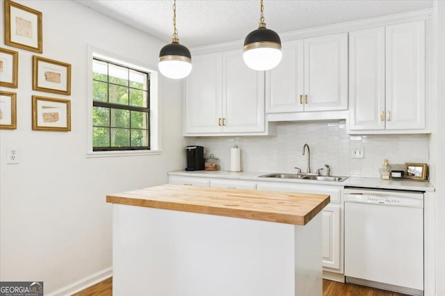711 Chapman St, Blackshear, GA 31516 - kitchen with dishwasher, butcher block countertops, backsplash, white cabinetry, and decorative light fixtures