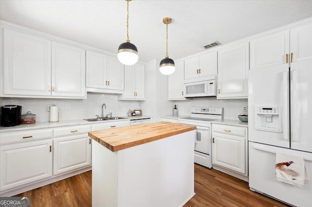 711 Chapman St, Blackshear, GA 31516 - kitchen with white appliances, butcher block counters, white cabinetry, and a textured ceiling